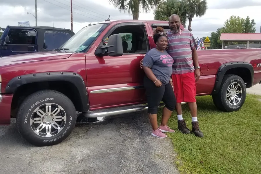 A happy Myhree Motors customer with their vehicle
