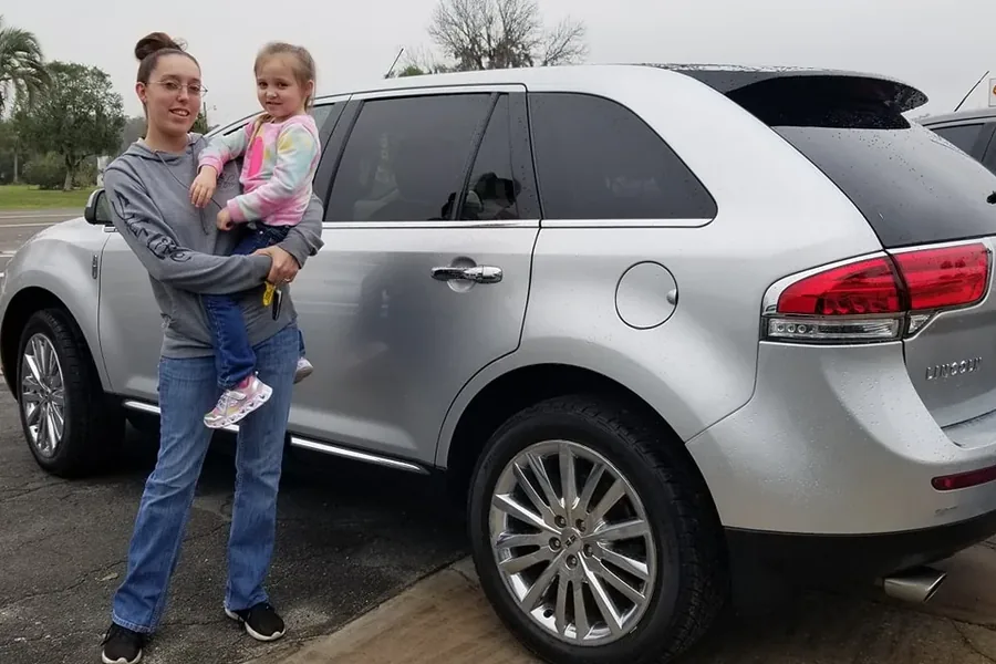 A happy Myhree Motors customer with their vehicle