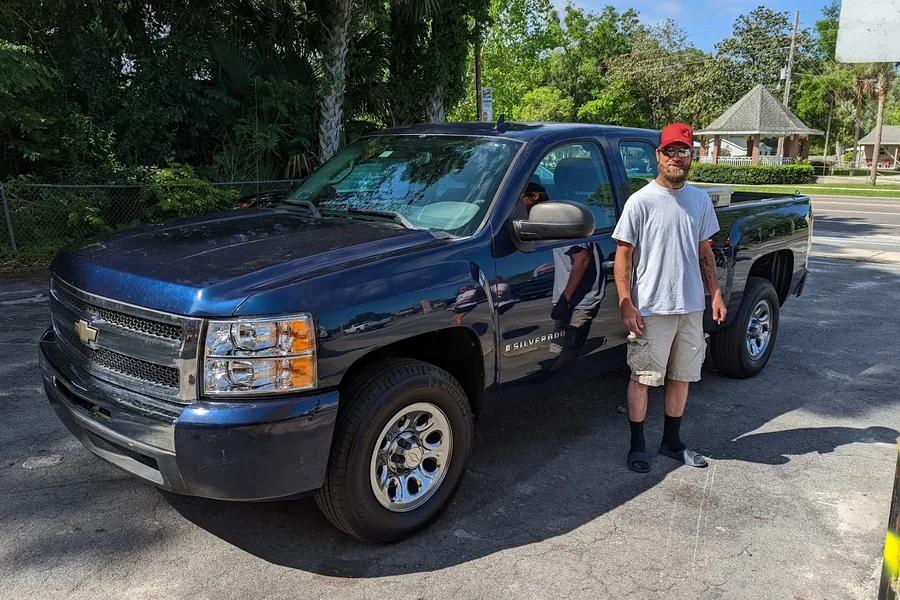 A happy Myhree Motors customer with their vehicle