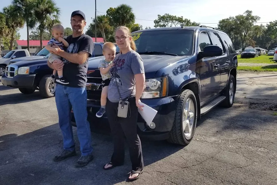 A happy Myhree Motors customer with their vehicle