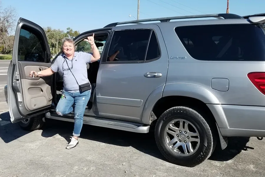 A happy Myhree Motors customer with their vehicle